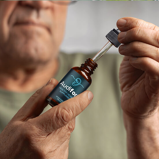 Person using Audifort liquid formula